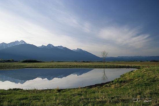 Kettle pond and the Mission Mountains, Ninepipe NWR, Montana, U.S.