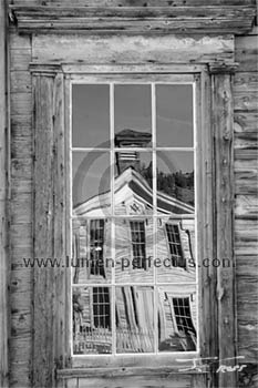 Bannack's Masonic Hall/school house reflected in a window in the assay office.