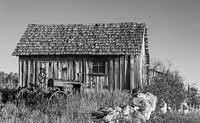 A small barn and its ancient, companion tractor, South Dakota, U.S.