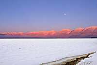 Mission Mountains at sunset with full moon, Montana, U.S.