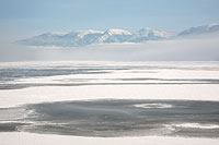 Flathead Lake ice and Mission Mountains in fog