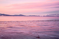 Flathead Lake ice and Mission Mountains after sunset
