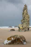 Stone and sand and stormy sky, Bandon Beach, Oregon, U.S.