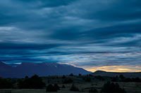 A bit of sunrise color, soon swallowed by storm clouds, near Montana's National Bison Range'