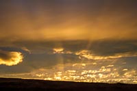 Sunset 'underlights' dark clouds west of Montana's Flathead Lake.