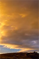 Sunset 'underlights' dark clouds west of Montana's Flathead Lake.