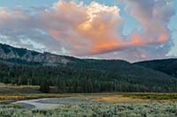 Pre-sunrise color in clouds over an autumn-dry Lamar River in Yellowstone National Park, Wyoming, U.S.