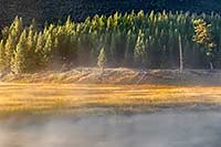Mist rises from the Madison river at sunrise, Yellowstone National Park, Wyoming, U.S.